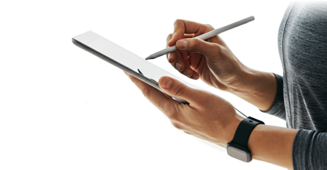 A person writing on a tablet with a pen